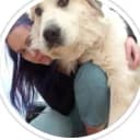 girl kneeling with a great pyrenees dog